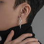 Silver thorn vine clip-on hoop earrings side view worn on model with black turtleneck