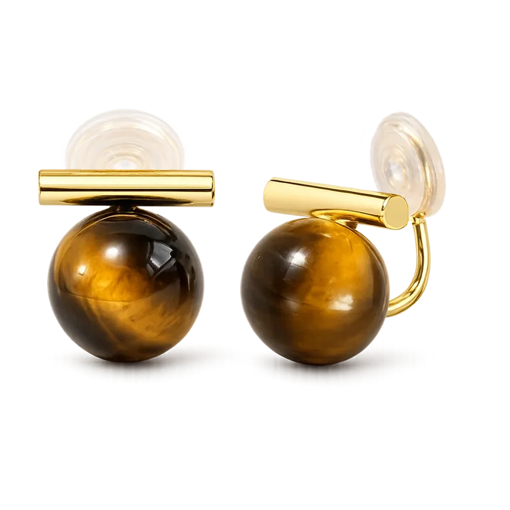 A pair of gold and tiger's eye stud earrings on a clean white background. Each earring features a polished round brown tiger's eye stone with a bar.