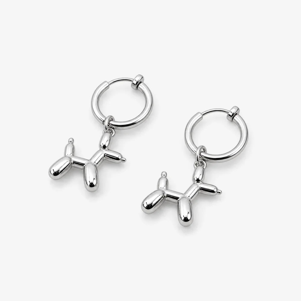 A pair of silver-toned hoop earrings with dangling balloon-shaped dog charms, shown on a clean light gray background.