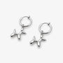 A pair of silver-toned hoop earrings with dangling balloon-shaped dog charms, shown on a clean light gray background.