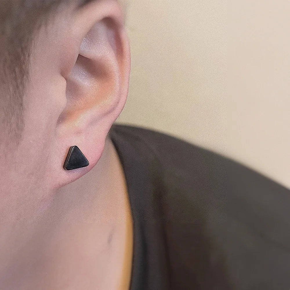 Black triangle magnetic stud earrings side view worn on ear, minimalist geometric design