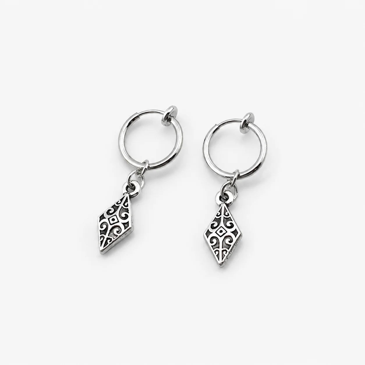 A pair of silver clip on hoop earrings with dangling filigree diamond charms, shown on a clean light gray background.