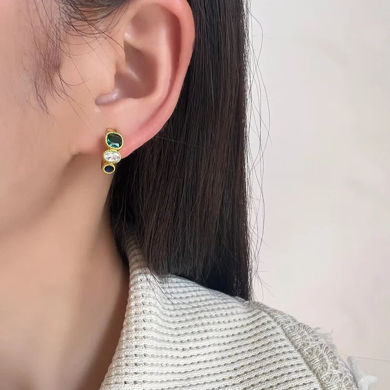 Triple Color Rhinestone Emerald Clip-On Earrings side view on model with black hair, gold tone metal setting