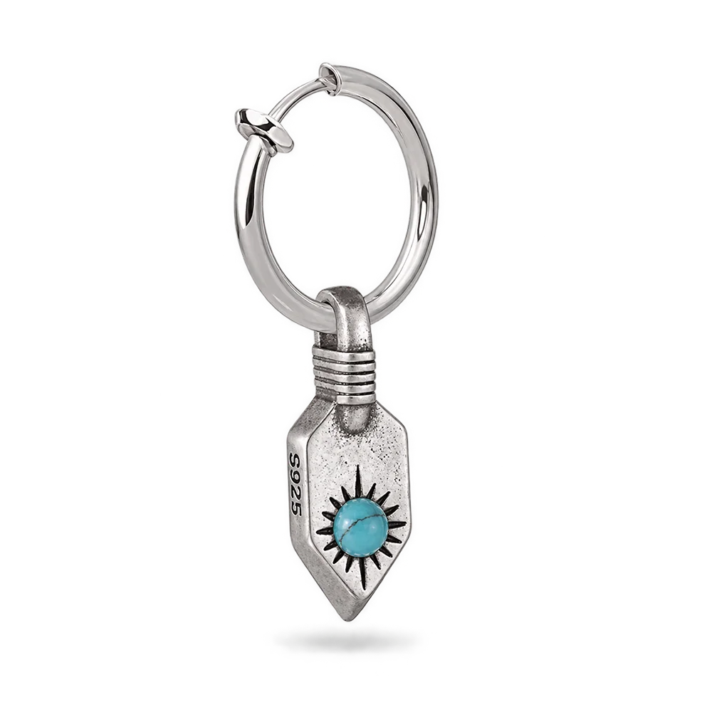 A sterling silver huggie hoop earring with a dangling shield-shaped charm featuring a turquoise stone sun motif, shown on a clean white background.