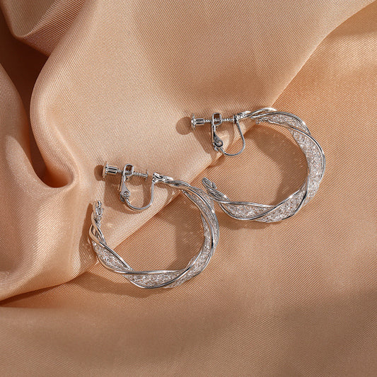 Step into a world of shimmer with our Glimmering Lattice Twist Clip-On Earrings in Silver. Screw back, no piercing required.