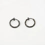Twisted Huggie Clip On Hoop Earrings in Black, front view on white background showing textured metal finish
