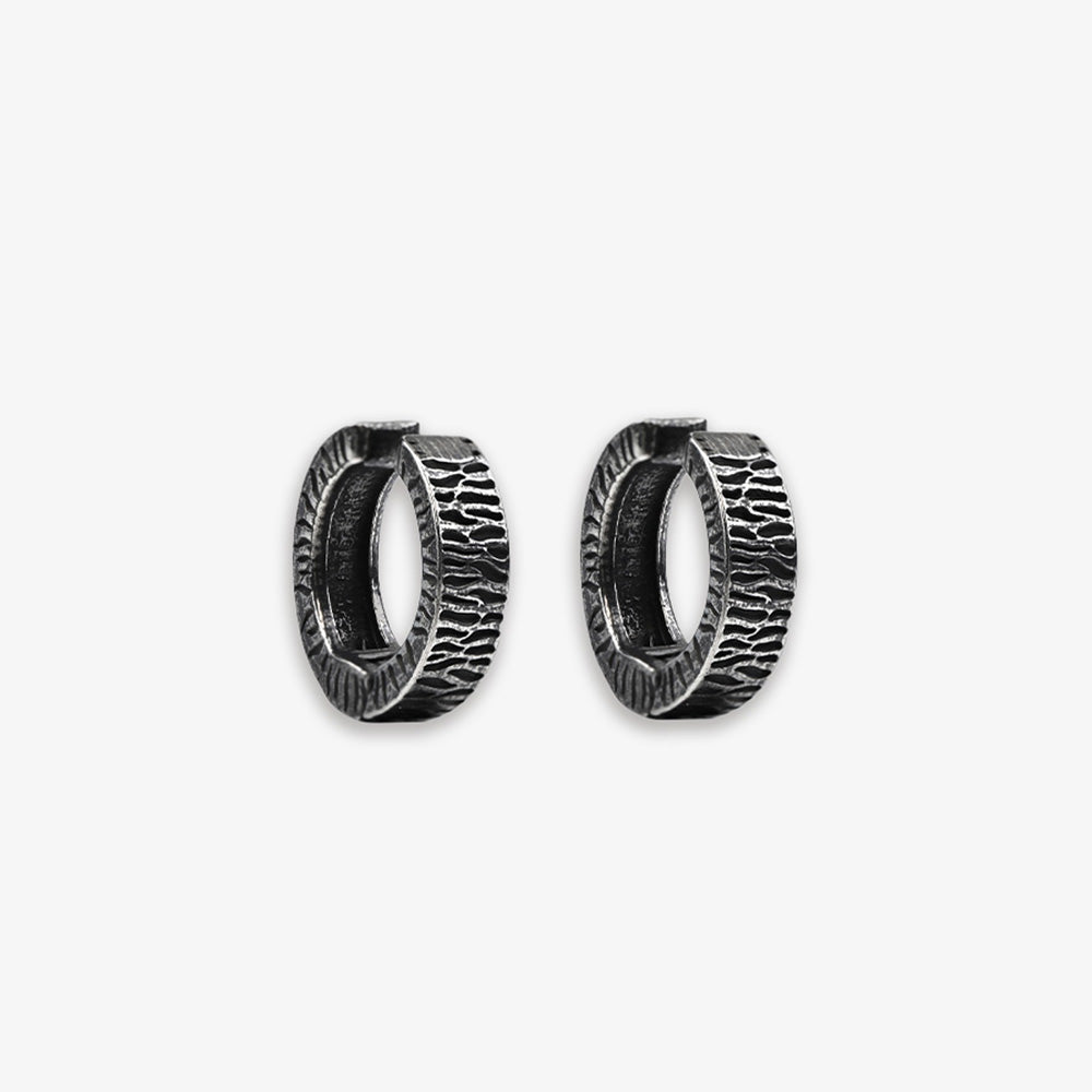 Titanium steel Vintage Tyre Black Clip-On Earrings with a hinged-back design, offering a punk look for men. The rugged texture mimics a tire's surface, perfect for daily wear and adding an edgy touch to any outfit. Ideal for those who appreciate industrial-inspired men's fashion accessories.