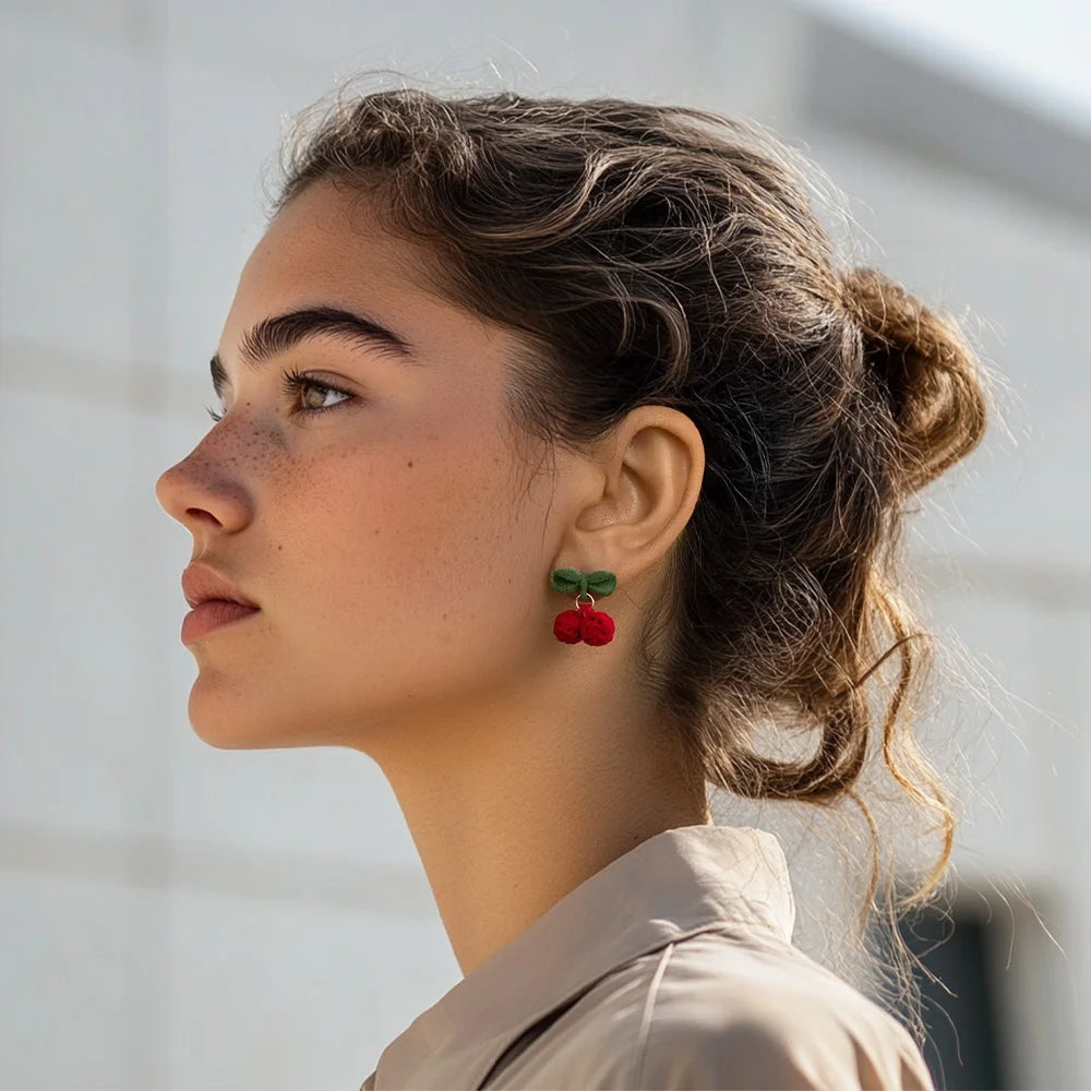 Velvet Cherry Clip-On Earrings side profile view on model wearing cream shirt