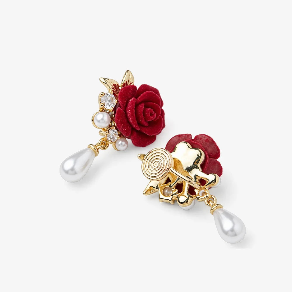 A pair of gold and red drop earrings featuring fabric roses, small pearl-like beads, clear rhinestones, and dangling pearl teardrops, shown on a light gray background.