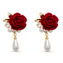 A pair of red rose drop earrings with gold-tone metal, faux pearls, and clear rhinestones on a plain white background.
