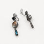 Vintage multi-gem drop clip-on earrings with smoky quartz and blue topaz stones on white background