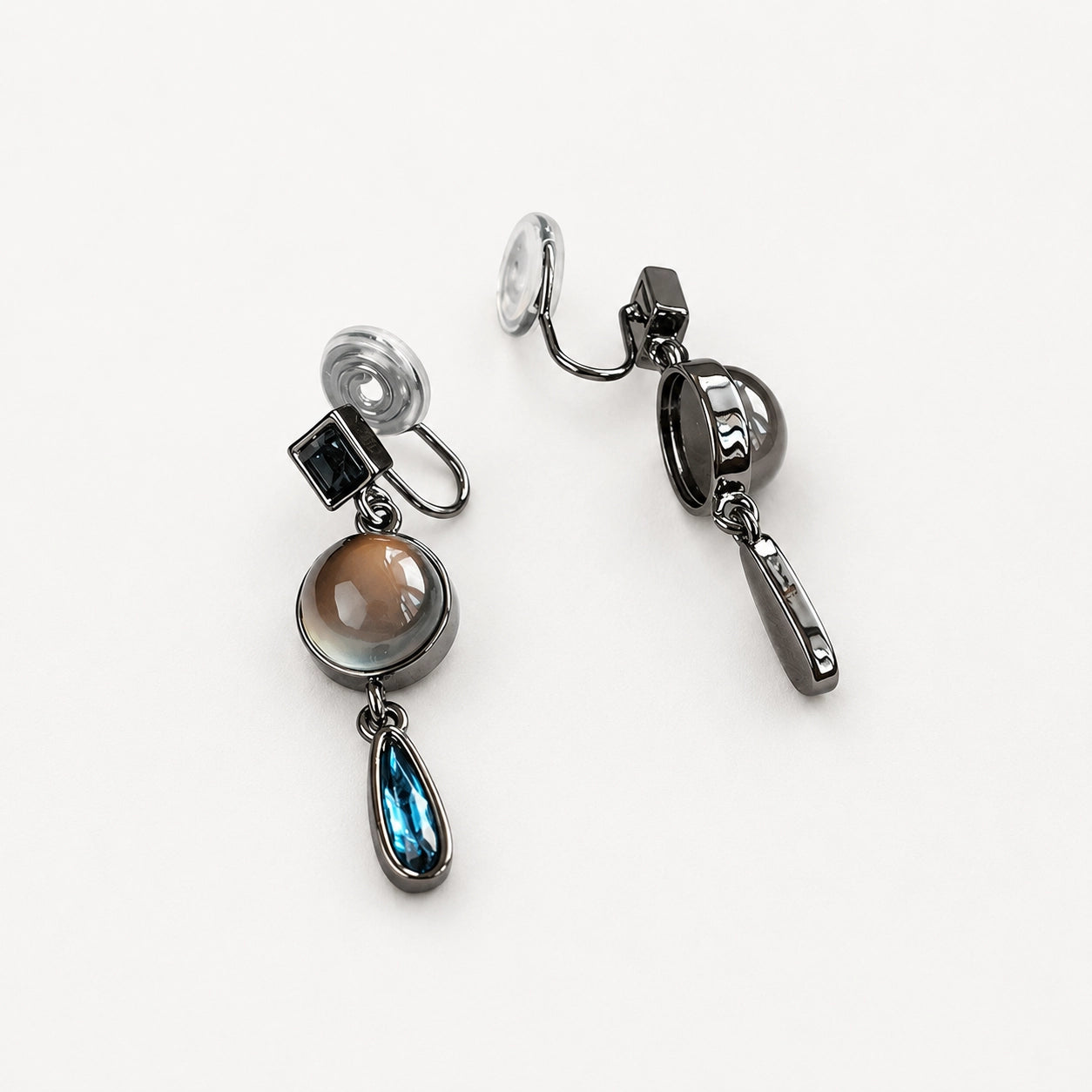 Vintage multi-gem drop clip-on earrings with smoky quartz and blue topaz stones on white background