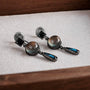 Vintage multi-gem drop clip-on earrings with smoky quartz and labradorite stones on white display cushion