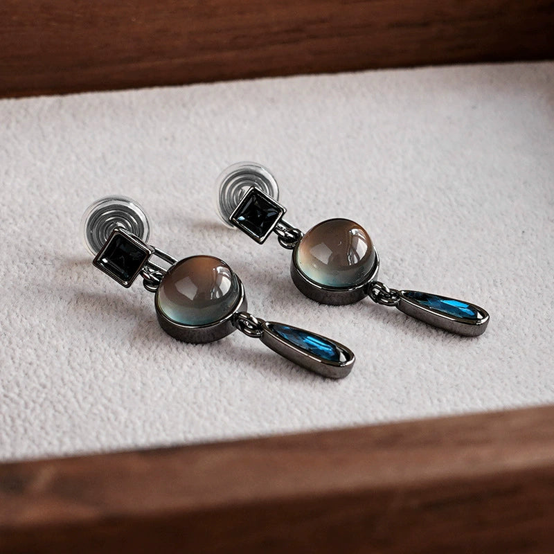 Vintage multi-gem drop clip-on earrings with smoky quartz and labradorite stones on white display cushion
