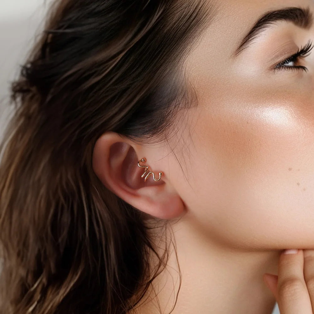 Model wearing the Wavy Tragus Cuff in Black, highlighting its elegant fit on the ear.