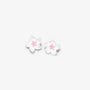 A pair of white cherry blossom stud earrings with textured petals and small pink centers, shown on a plain light gray background.