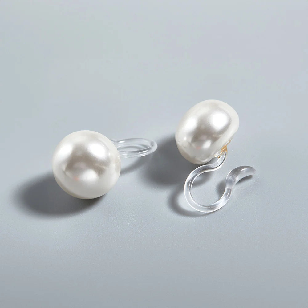 Close-up of White Pearl Invisible Clip-On Earrings highlighting the classic and timeless look.