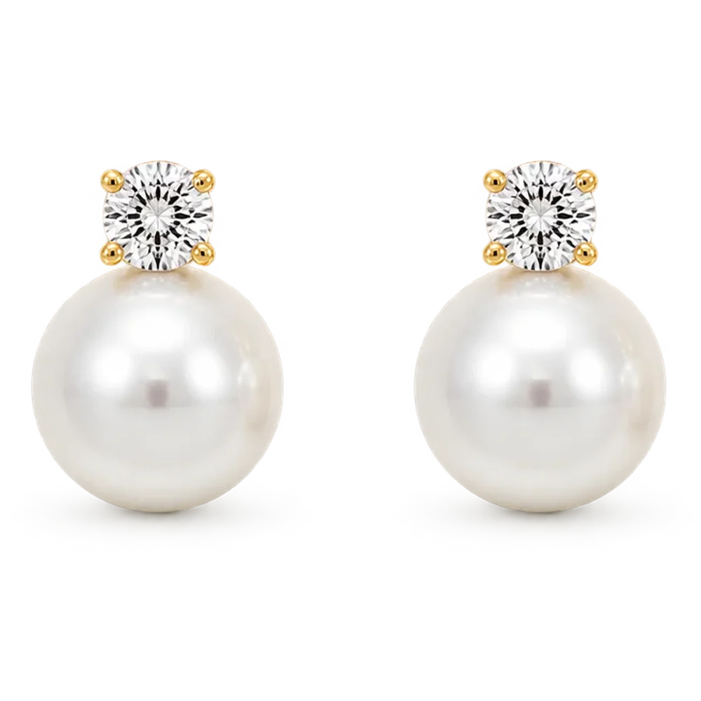 A pair of gold and pearl drop earrings with clear gemstones, shown on a plain white background.