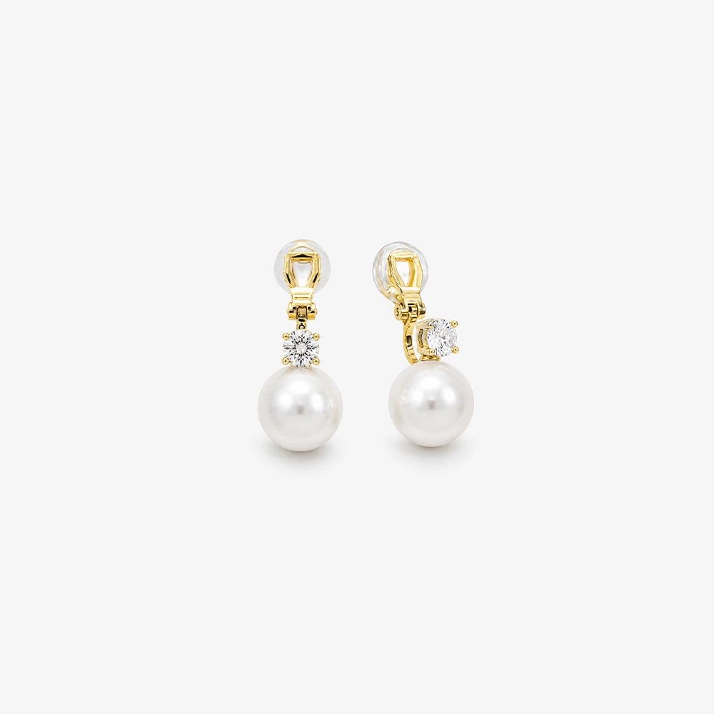 Pair of White Pearl Drop Clip-On Earrings in Gold Setting, capturing the elegant design and color contrast.