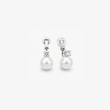 Pair of White Pearl Drop Clip-On Earrings in Silver Setting displayed, capturing the elegant design and color contrast.