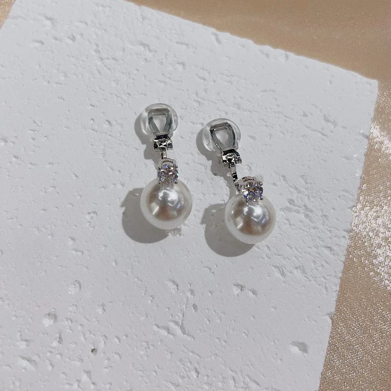 Model wearing the White Pearl Drop Clip-On Earrings, demonstrating the secure and comfortable fit of the U-type clip-on closures and the stylish appearance.