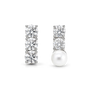 Asymmetrical clip-on earrings: a three-stone cubic zirconia bar and a two-stone CZ bar with a shell pearl drop