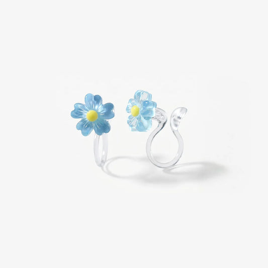 Close-up of the translucent blue resin petals and the clear stud clip-on mechanism for non-pierced ears.