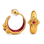 A pair of gold hoop earrings with red enamel inlays, floral gold details, and small red gemstones, shown on a clean white background.