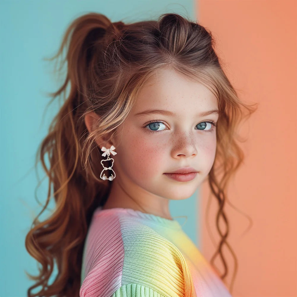 Bow-Tied Bear Pearl Clip-On Earrings side view on young girl with red hair and colorful rainbow sweater