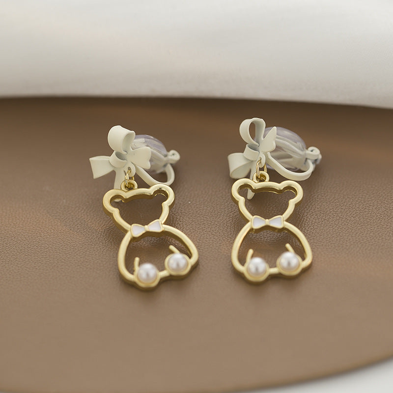 Spruce up her look with the whimsy of our "Bow-Tied Bear Pearl Clip-On Earrings." These delightful earrings showcase playful bears adorned with classic pearls and charming bows, perfect for young fashionistas who love a bit of fun with their style. Easy to wear and gentle on ears, they make dressing up a joy!