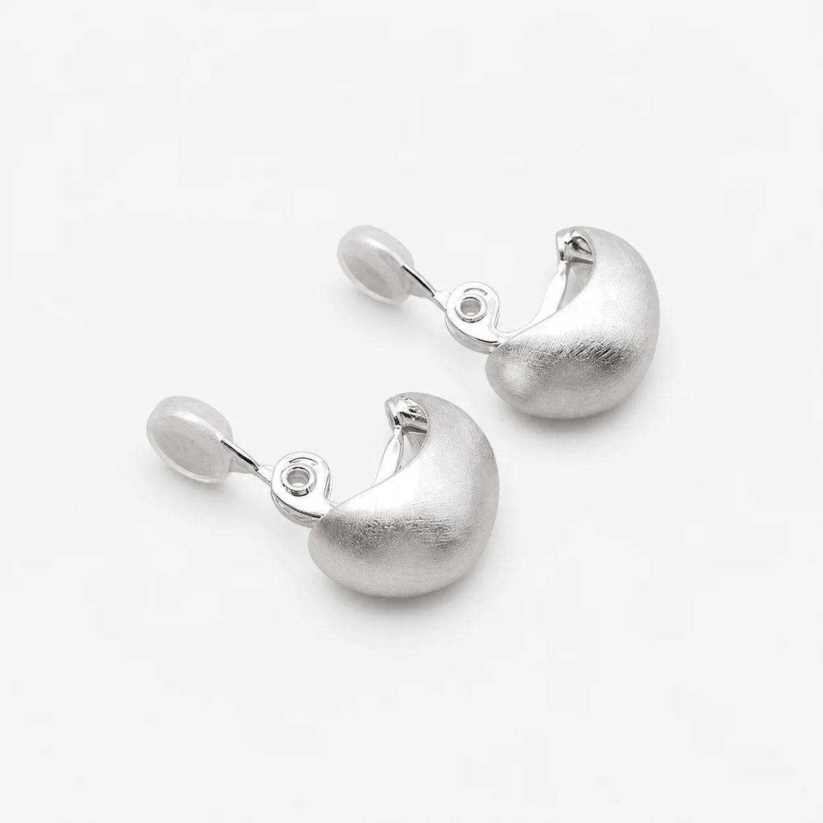 Back view of brushed dome clip-on earrings showing the adjustable hinged clip