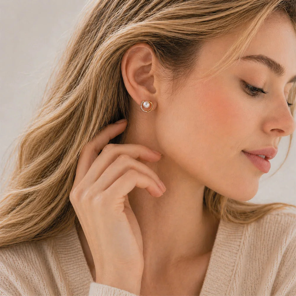 Side view of a woman wearing gold celestial pearl crescent clip on earrings for a minimalist look.