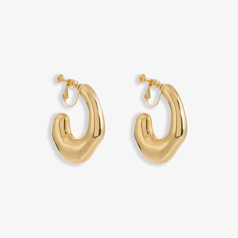 Chunky Curved Hoop Clip-On Earrings in Gold — pair on plain background, sculptural curved design