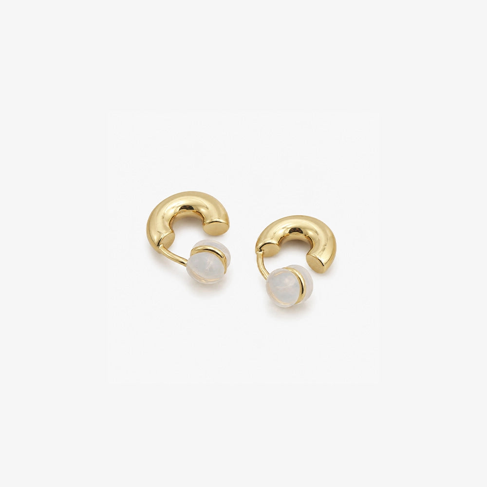 Chunky gold clip on huggie hoop earrings showing the cushioned clip on closure