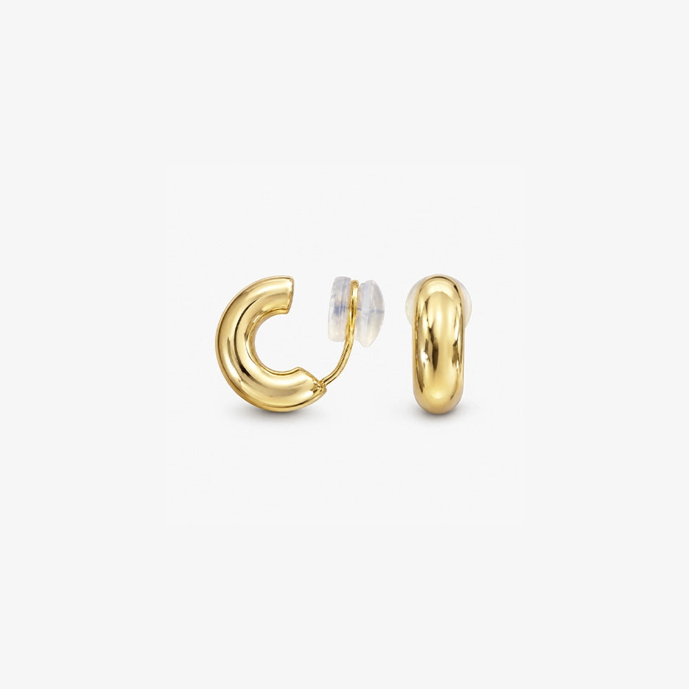 Pair of chunky gold clip on huggie hoop earrings shown from the front