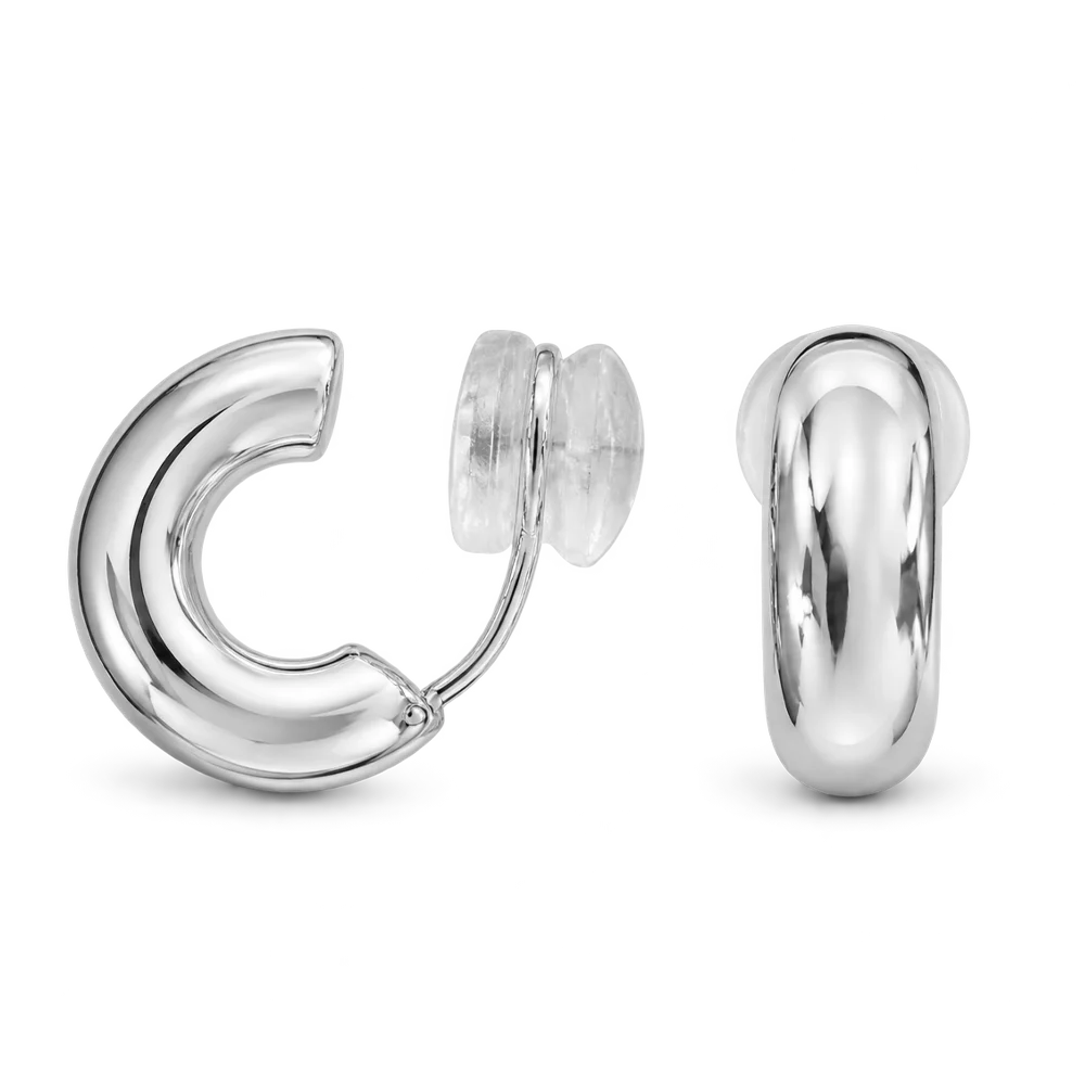 A pair of polished silver huggie hoop earrings shown on a clean white background, with one earring facing forward and the other angled to show the side profile and backing.