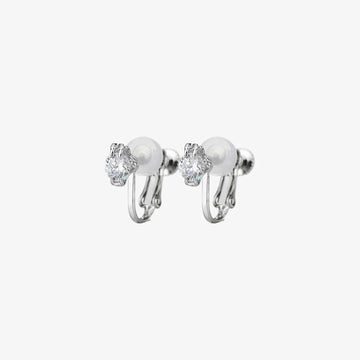 A pair of classic solitaire clip-on stud earrings with clear, round-cut cubic zirconia stones and comfortable cushioned backs, shown on a white background.