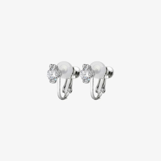 A pair of classic solitaire clip-on stud earrings with clear, round-cut cubic zirconia stones and comfortable cushioned backs, shown on a white background.