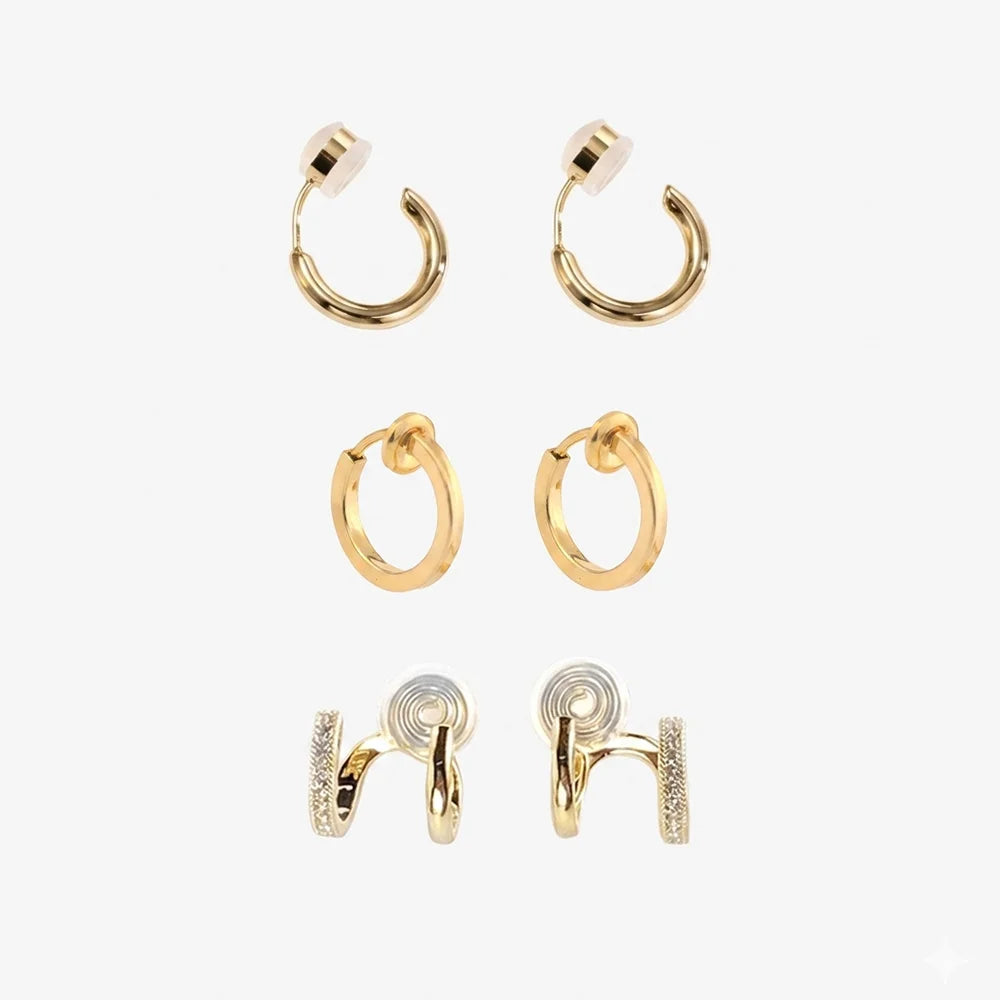 Set of 3 pairs of gold clip-on hoop earrings on a white background.