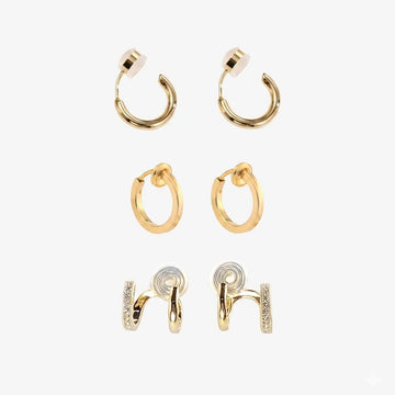 Set of 3 pairs of gold clip-on hoop earrings on a white background.