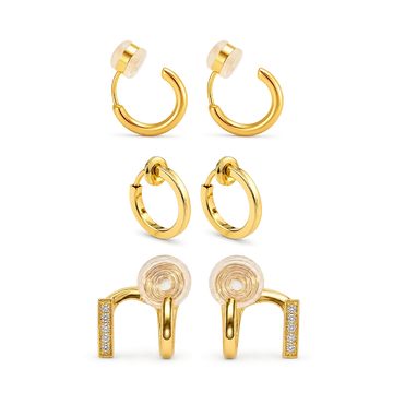 Set of 3 pairs of gold clip-on hoop earrings on a white background.