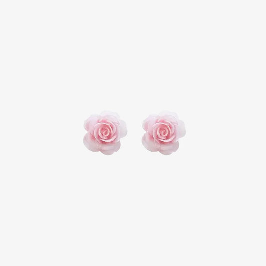 A pair of dainty pink rose magnetic stud earrings, showcasing their delicate floral design, isolated on a white background.
