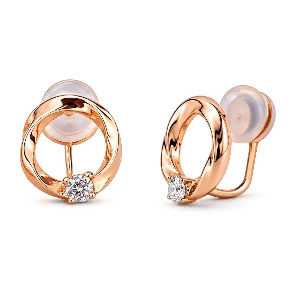 A pair of rose gold hoop earrings with a small round-cut clear gemstone at the base of each hoop and translucent silicone ear cushions, shown on a plain white background.