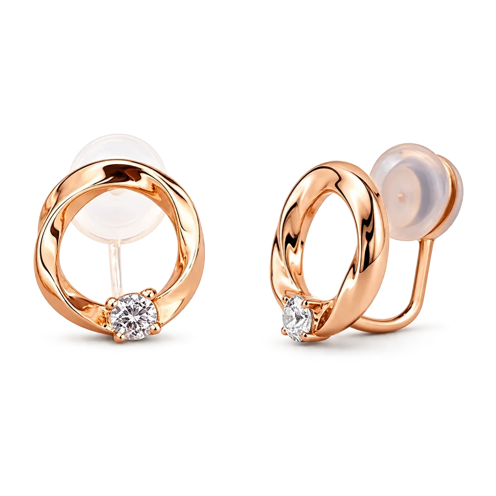 A pair of rose gold hoop earrings with a small round-cut clear gemstone at the base of each hoop and translucent silicone ear cushions, shown on a plain white background.