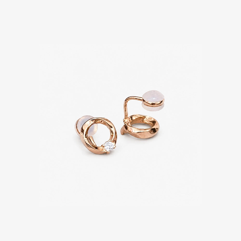 Elegant rose gold twisted circle stud earrings featuring a single brilliant-cut solitaire diamond accent