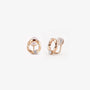 Pair of 18K rose gold twisted circle stud earrings with a central round solitaire stone on a clean white background.