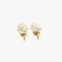 A pair of white resin flower clip-on earrings with comfortable mosquito coil clips displayed on a white surface next to a satin cloth.