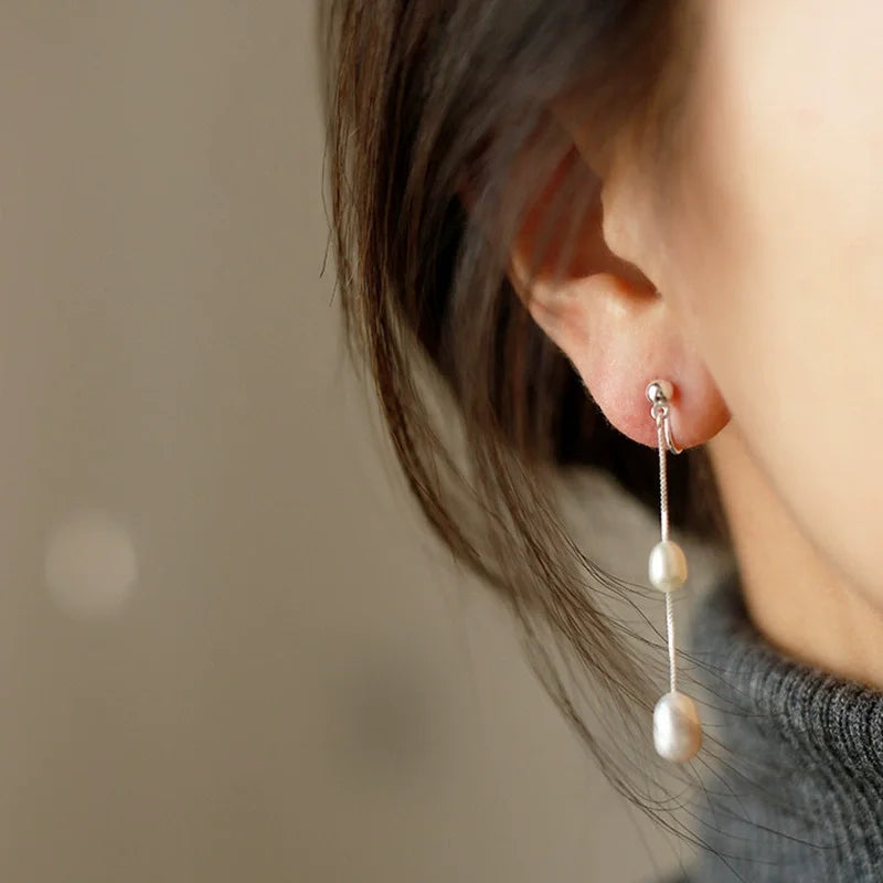 Double pearl bridal clip-on earring worn on a non-pierced earlobe