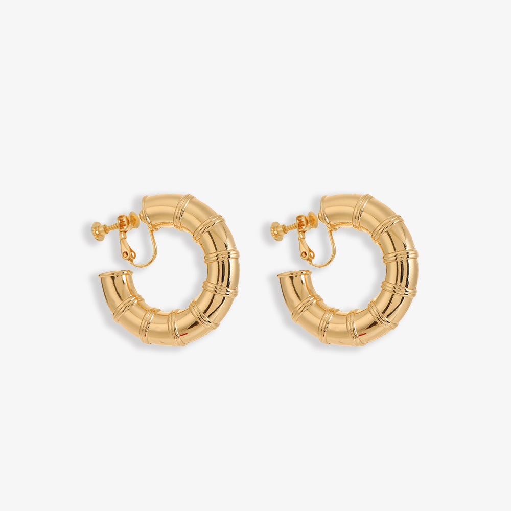 These Bamboo Hoop Clip-On Earrings in polished gold alloy exude an iconic style. Fastened securely with screw-back clips, they bring a touch of nature-inspired elegance to your ensemble, perfect for any occasion that calls for a hint of sophistication.