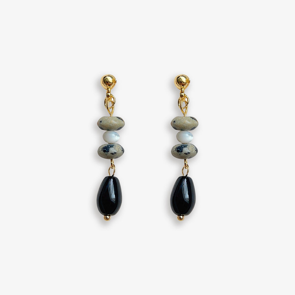 Black Gemstone Drop Clip-Ons: Boho Chic for Non-Pierced Ears. Crafted with black gemstone (stone) and resin, these earrings offer earthy elegance. The coil clip-on closure ensures comfortable wear, making them a versatile and stylish choice for any outfit.